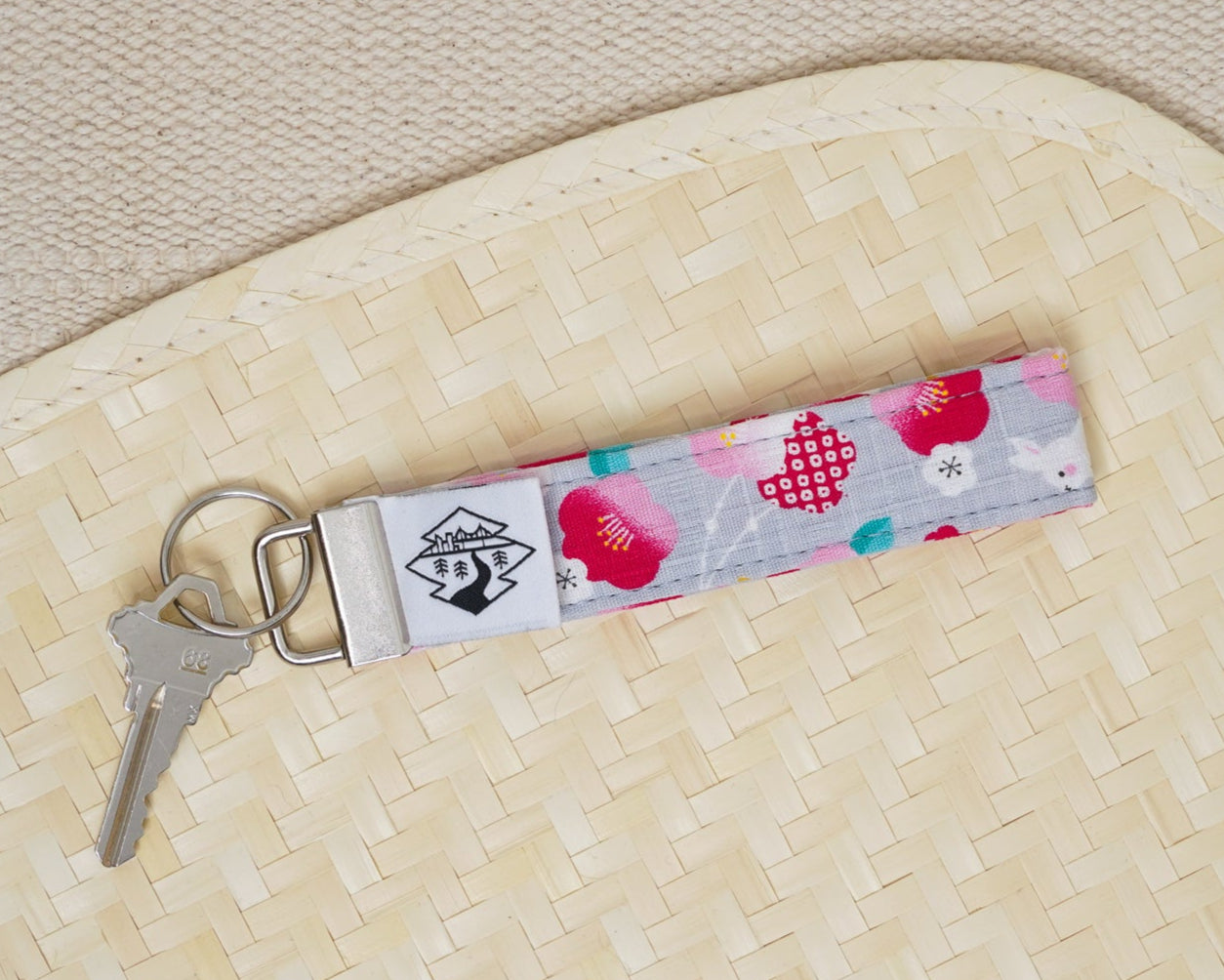 Keychain with floral design on a textured surface