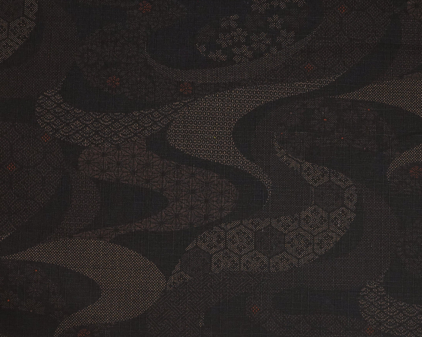 Dark fabric with a subtle pattern and a ruler at the bottom for scale.