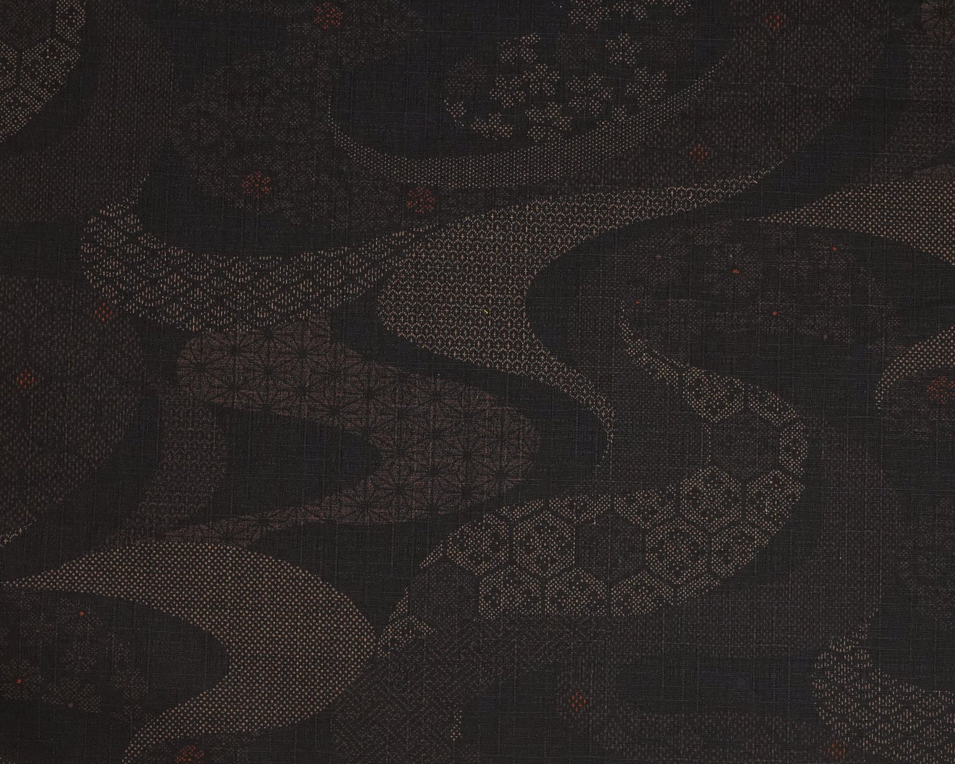 Dark fabric with a subtle pattern and a ruler at the bottom for scale.