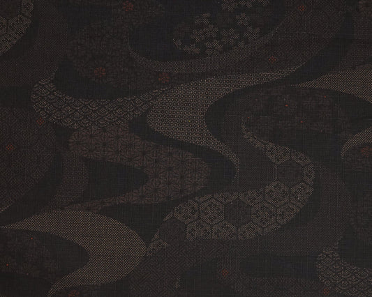 Dark fabric with a subtle pattern and a ruler at the bottom for scale.