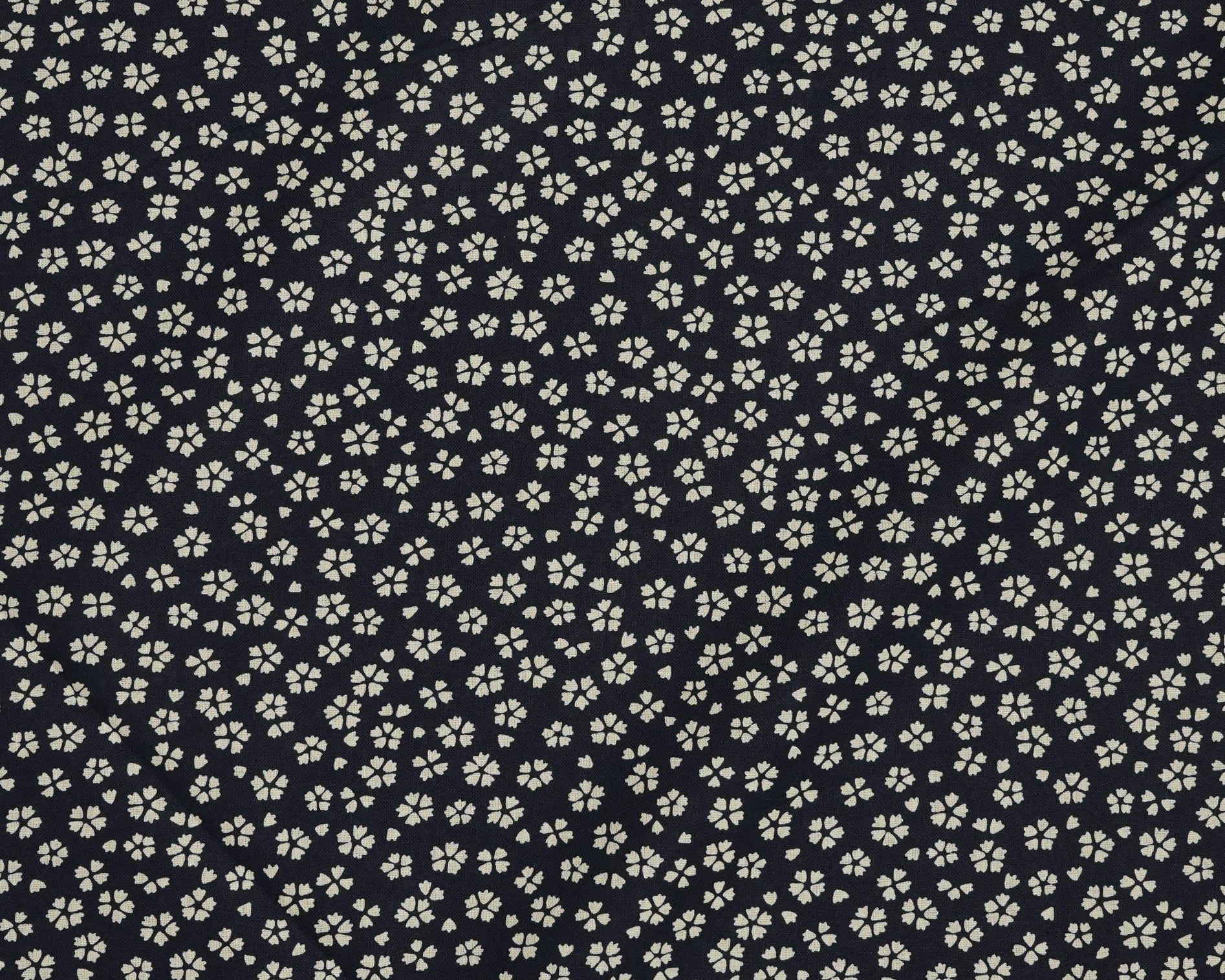 Small white floral pattern on a dark navy background