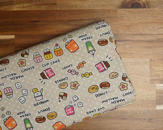 Kawaii Snacks on Beige cotton fabric, folded on the bolt