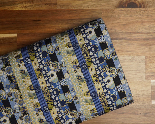 Blue Stripes with Metallic Floral cotton dobby fabric, folded on the bolt