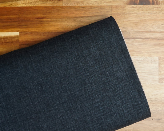 Heathered Solid Dobby fabric in Navy Blue, folded on the bolt