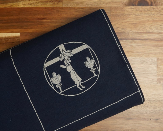 Usagi Rabbit Four Seasons Panel in Navy Blue, folded on the bolt