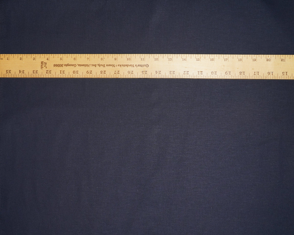 Solid Indigo cotton linen canvas, laid flat with a ruler for scale