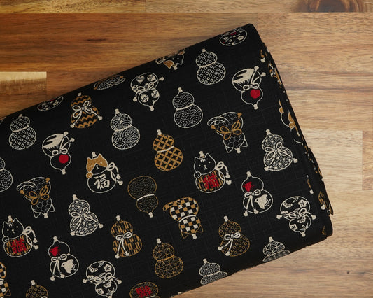 Gourds and Cats on Black cotton dobby fabric, folded on the bolt