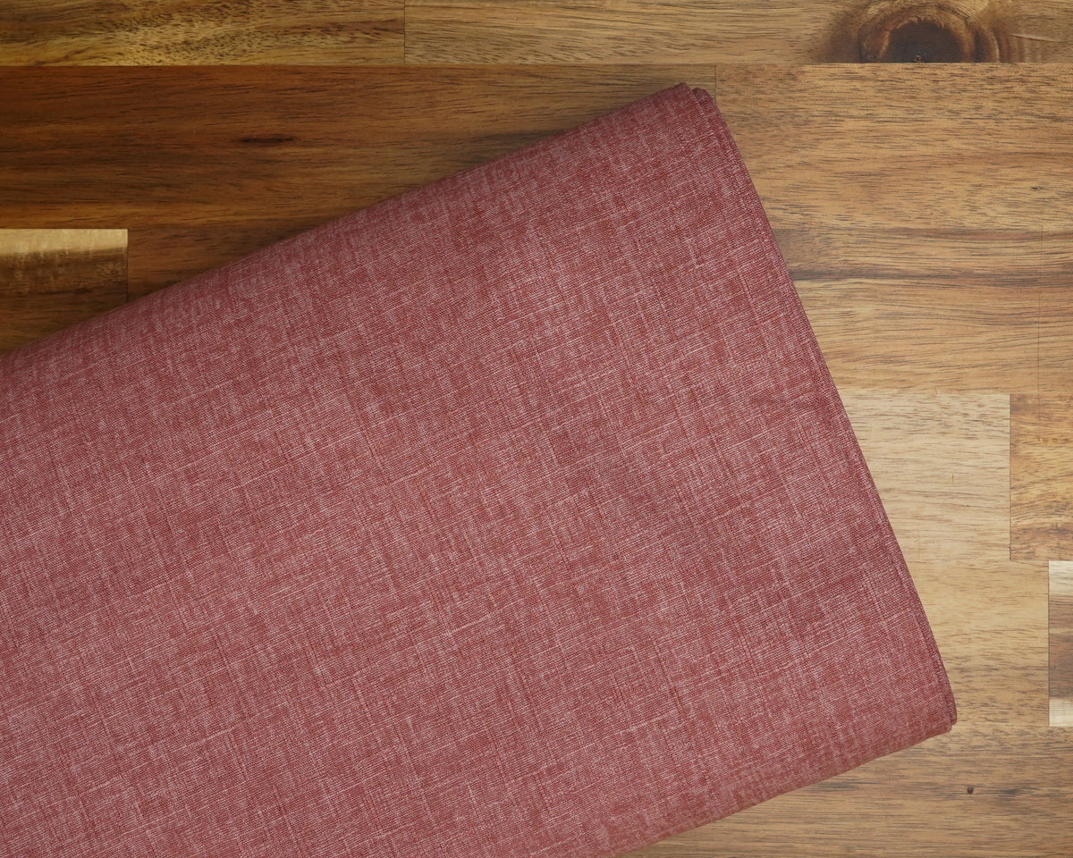 Heathered Solid Dobby fabric in Peony, folded on the bolt