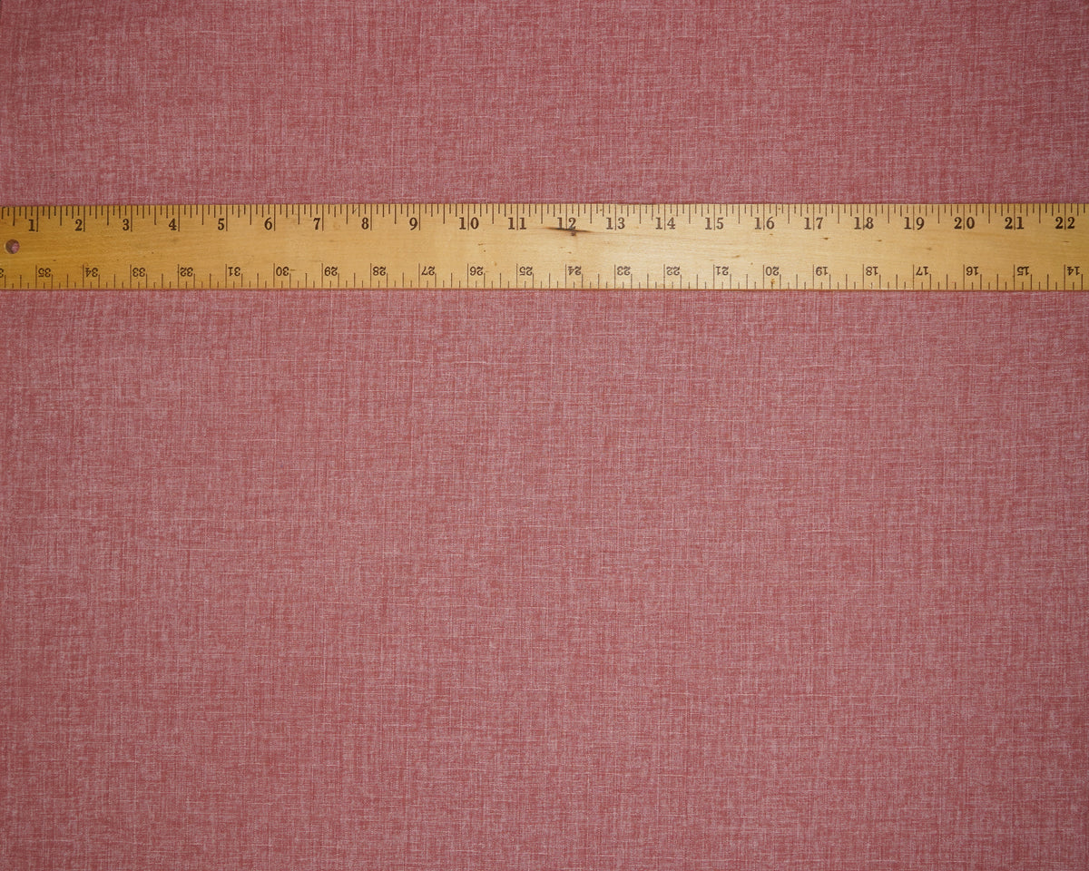 Heathered Solid Dobby fabric in Peony, laid flat with a ruler for scale