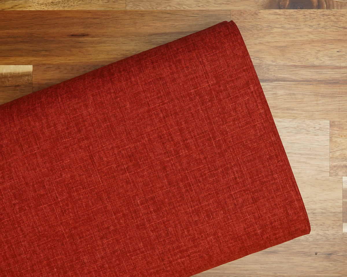 Heathered Solid Dobby fabric in Tomato Red, folded on the bolt