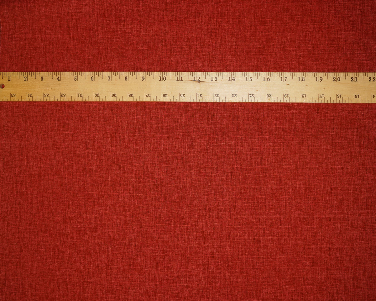Heathered Solid Dobby fabric in Tomato Red, laid flat with a ruler for scale