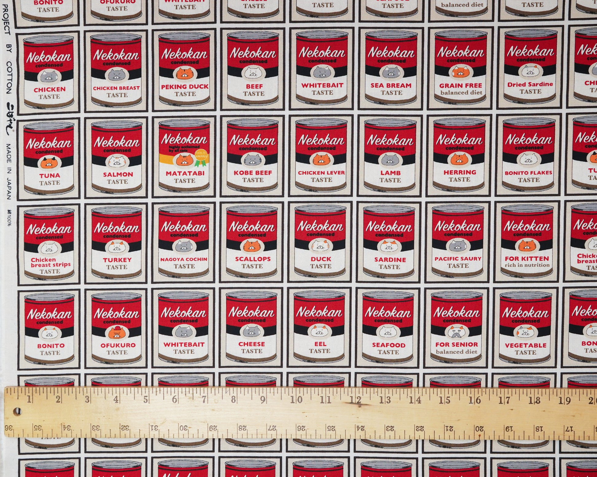 Pattern of Nekokan pet food cans with a ruler at the bottom for scale.