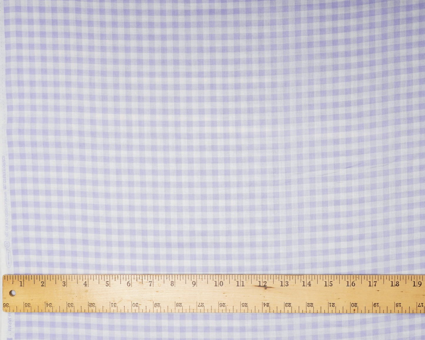Checkered fabric with a ruler at the bottom for scale