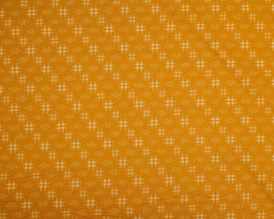 Patterned fabric with a small geometric design on a mustard yellow background