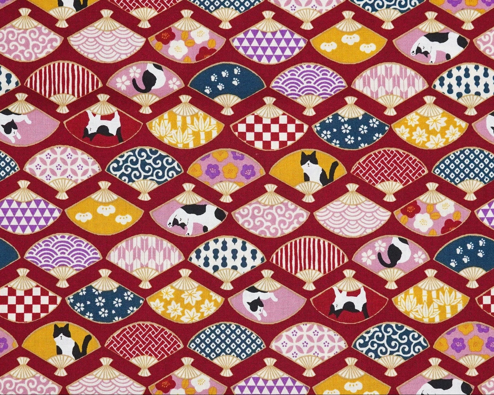 Patterned fabric with colorful traditional designs on a red background