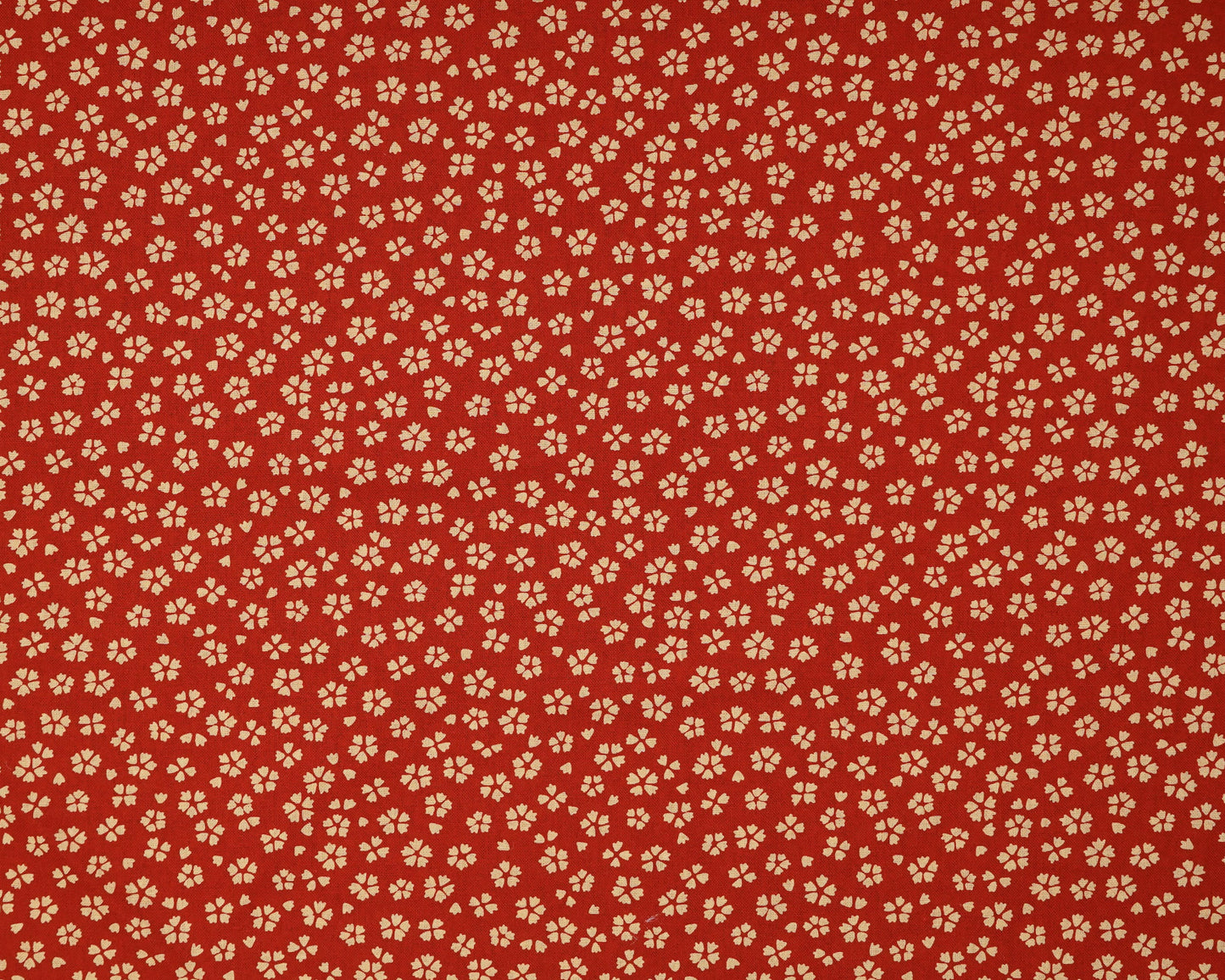 Red fabric with small beige floral pattern
