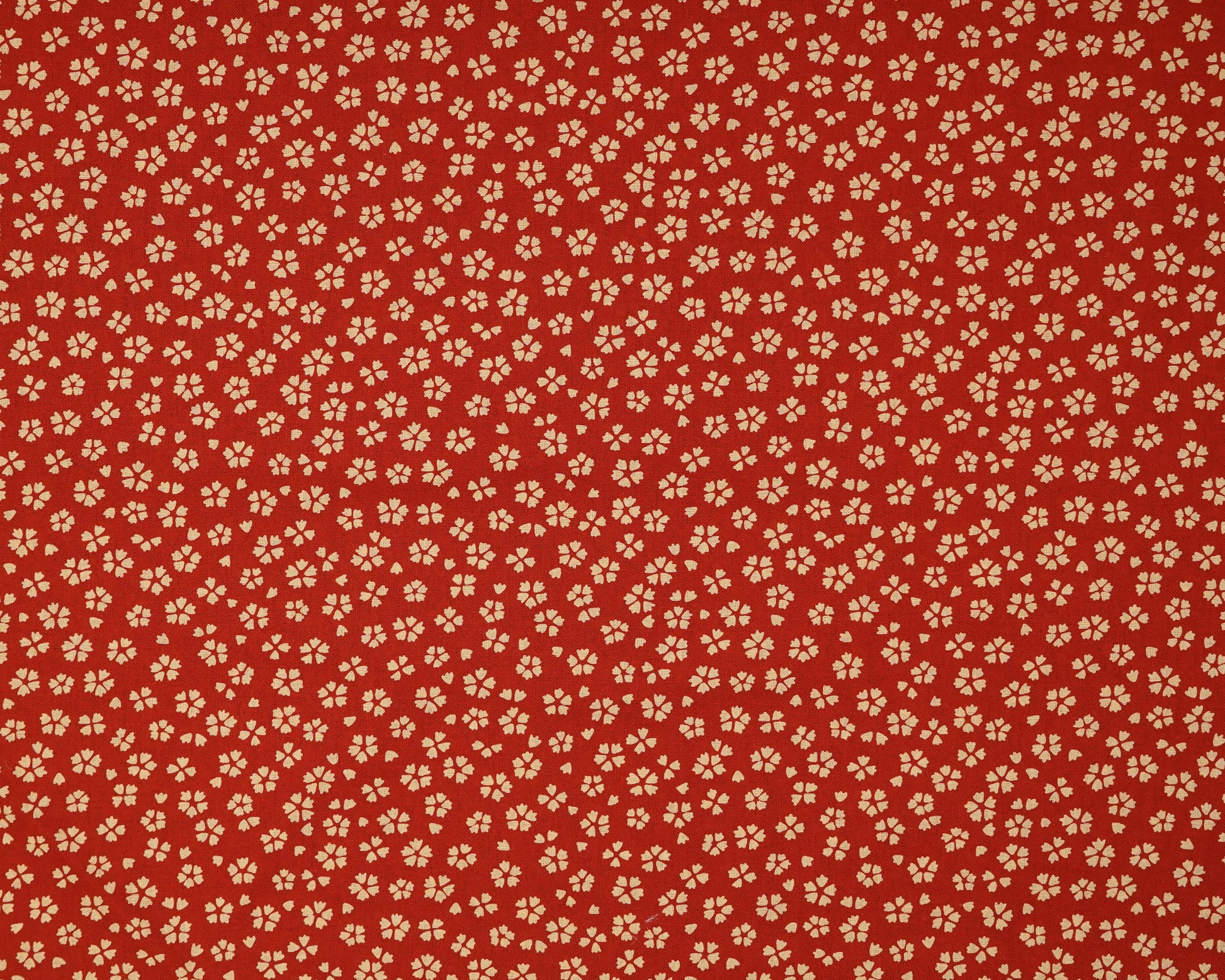 Red fabric with small beige floral pattern