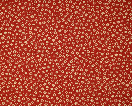 Red fabric with small beige floral pattern