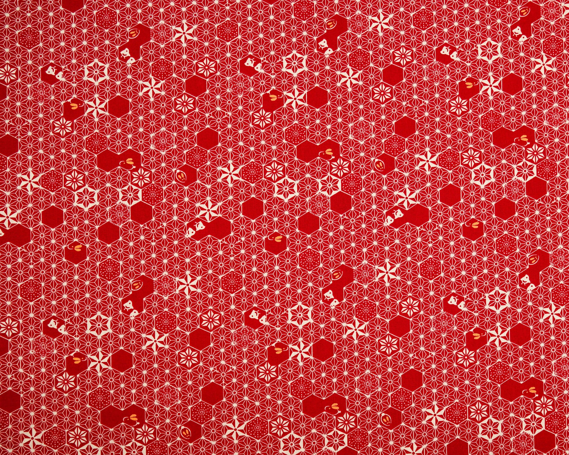Red patterned fabric with geometric shapes on a red background