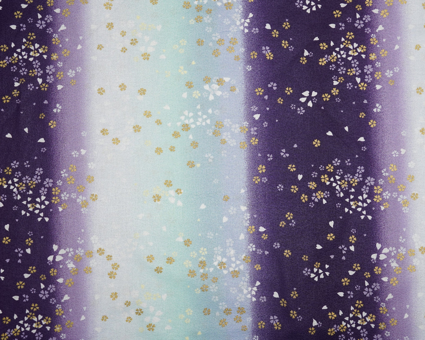 Gradient fabric pattern with floral design transitioning from purple to blue.