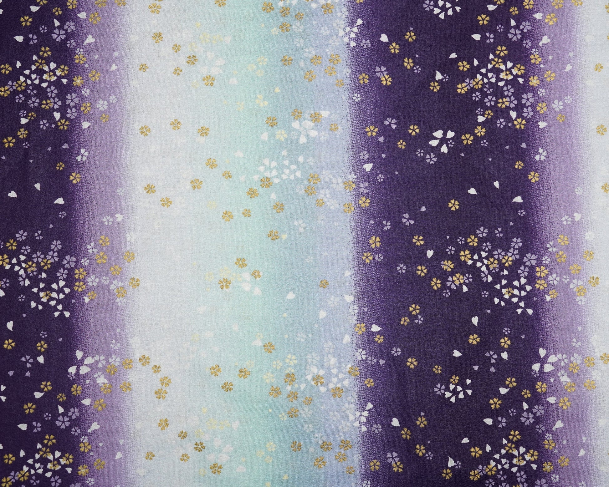 Gradient fabric pattern with floral design transitioning from purple to blue.