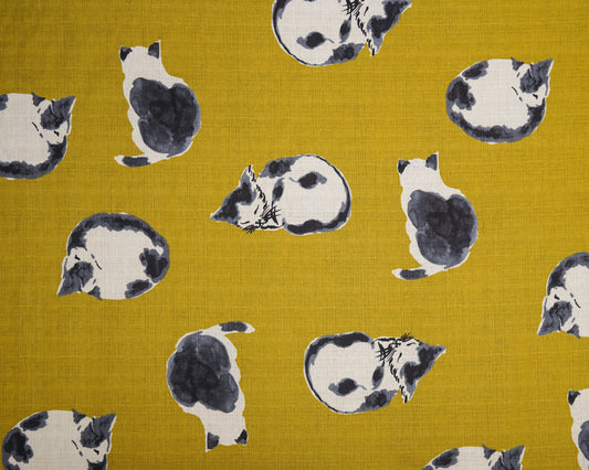 Pattern of black and white cats on a mustard yellow fabric background