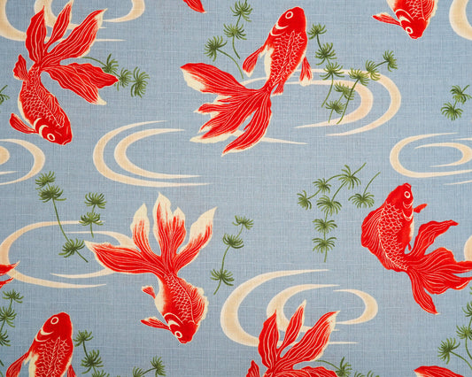 Pattern of red koi fish on a blue background with green plants and white swirls.