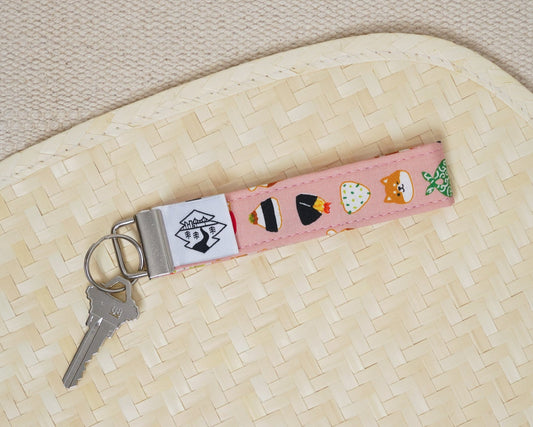 Keychain with cartoon sushi design on a woven mat