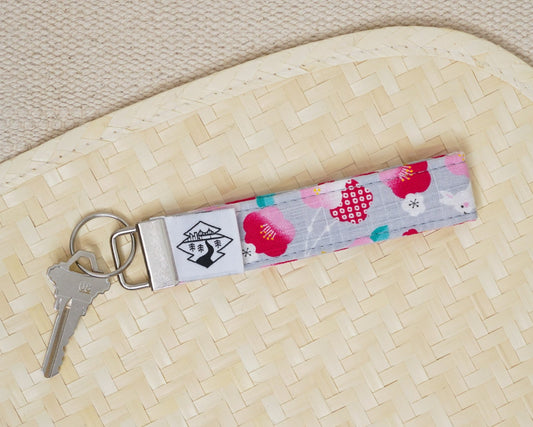 Keychain with floral design on a textured surface